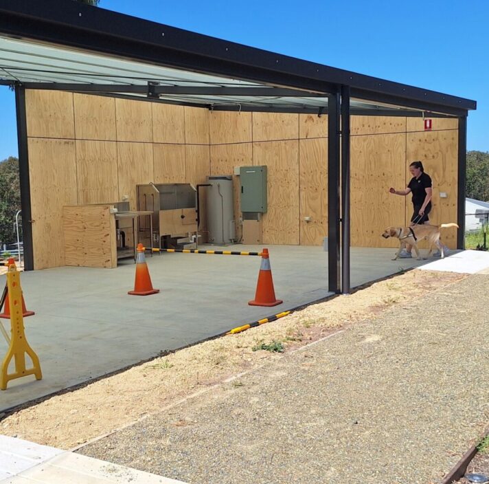 Two Orientation and Mobility Instructors take trainee Guide Dogs through their paces in the new Kent Training Plaza