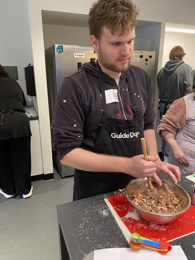 Sam in cooking group making chocolate and coconut balls
