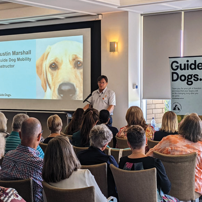 Justin Marshall, Guide Dog Mobility Instructor speaking at the bequestor morning tea