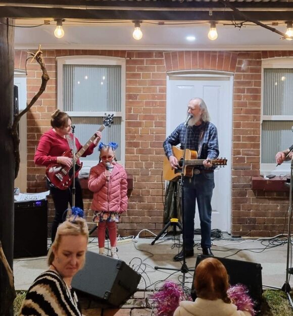 Stella singing with a band