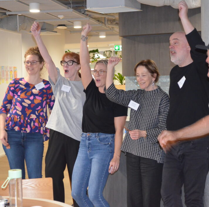 a group of people celebrating after finishing the game