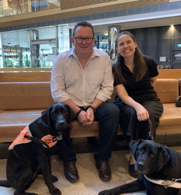 Kelly with her Puppy Raiser Darren and Kate.