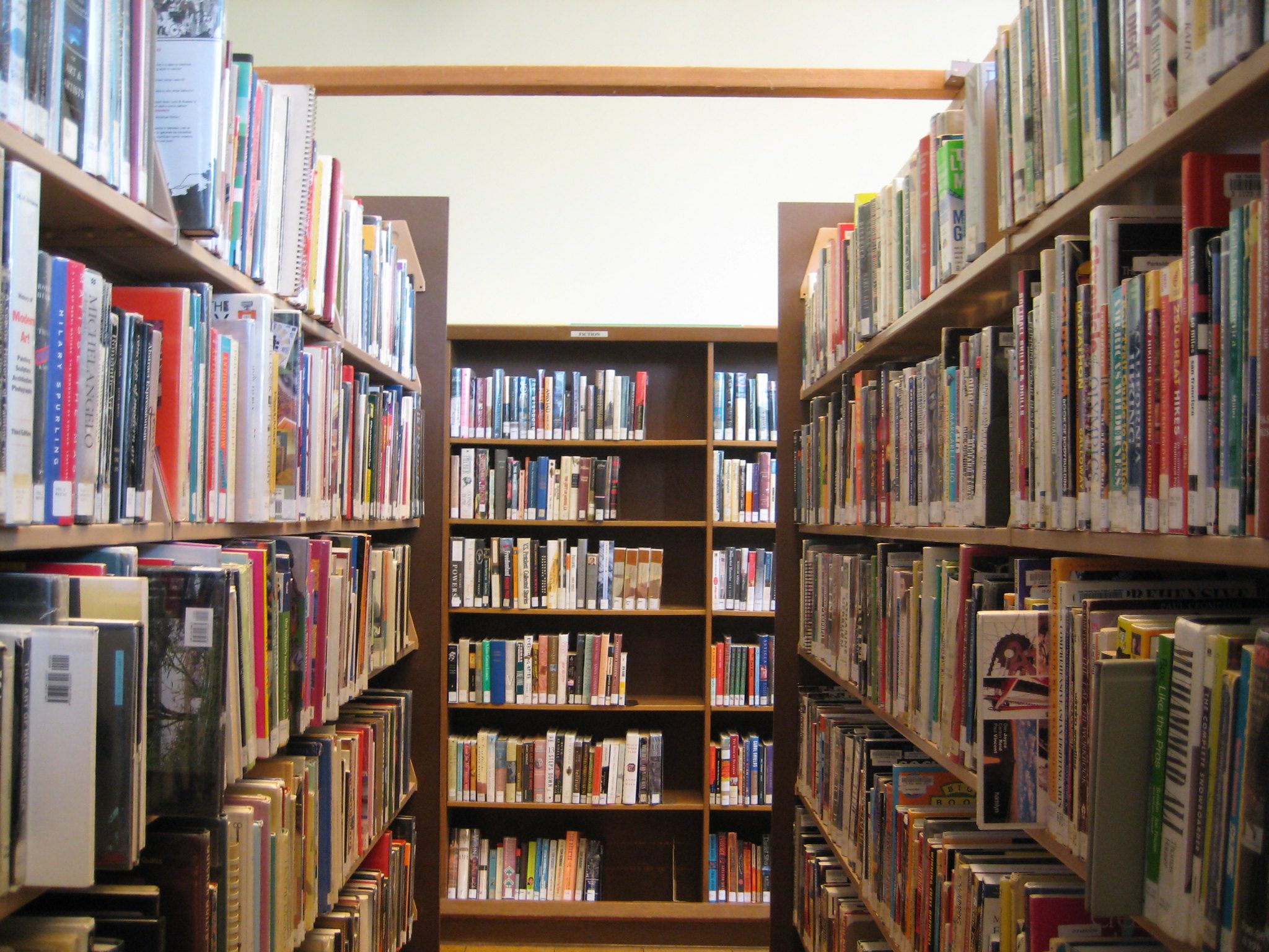 A hallway of bookshelves in a library.