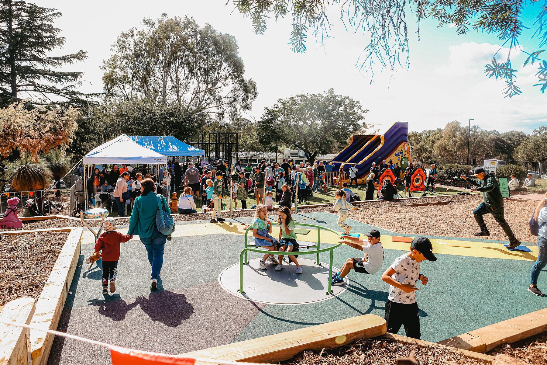 Children playing in playground during Guide Dogs community fair