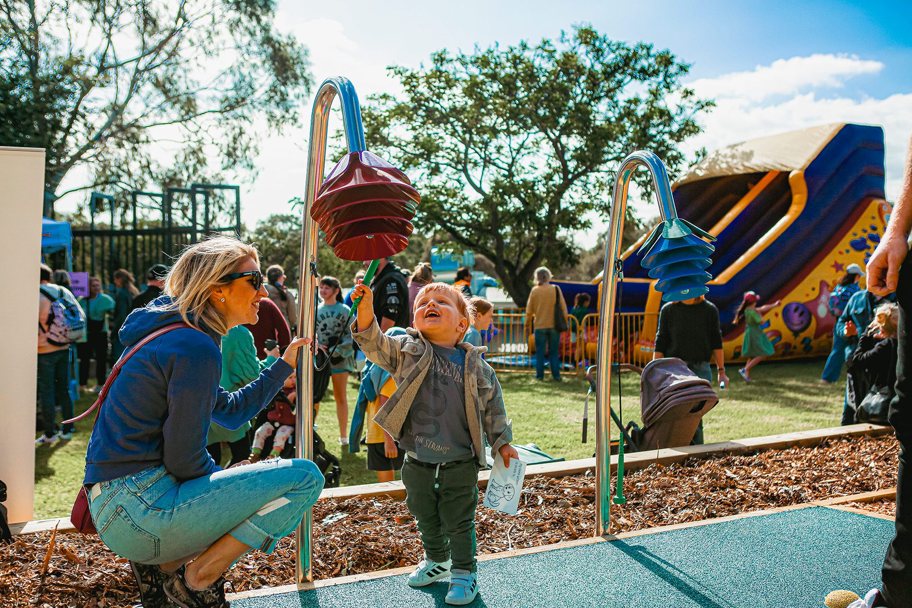 Children playing in playground with parents