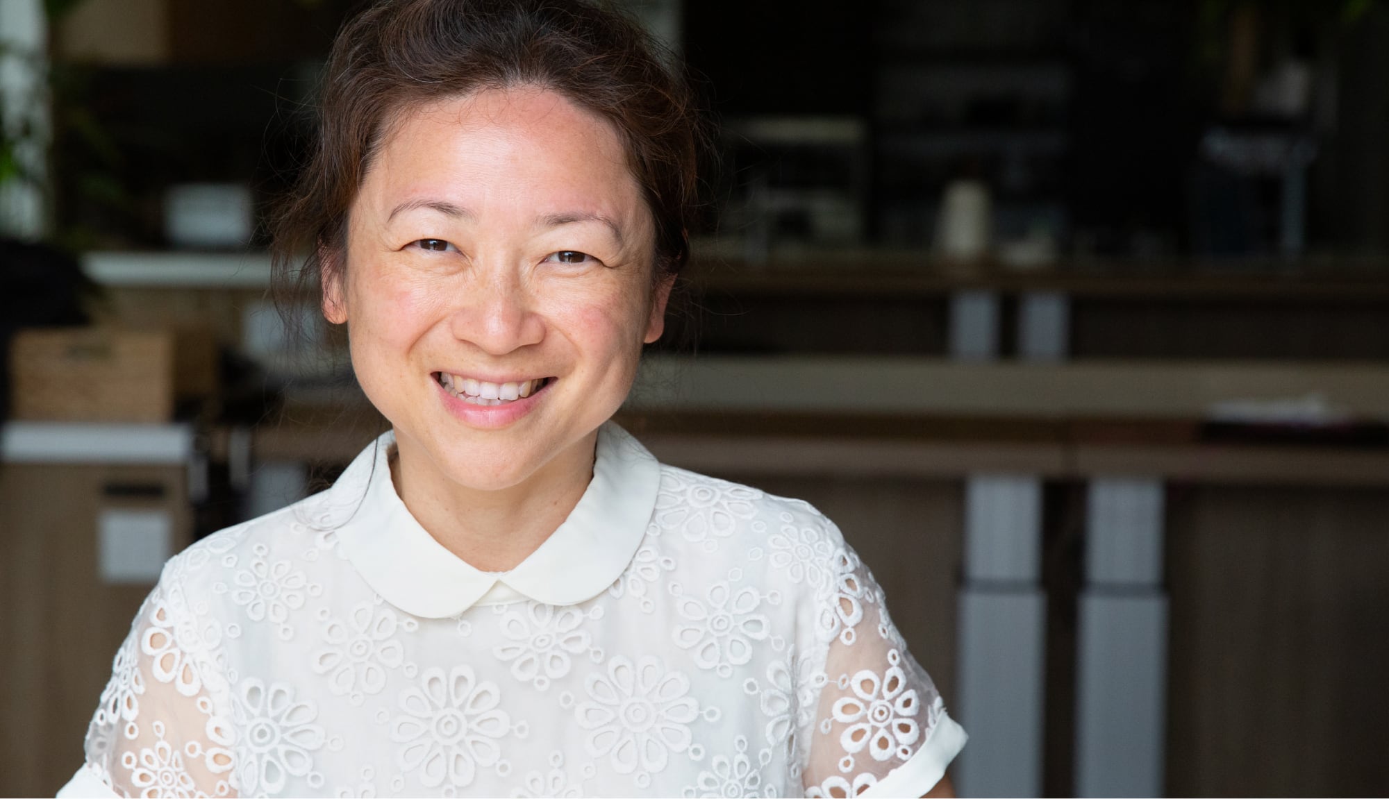 A person with a big smile looking straight at the camera.