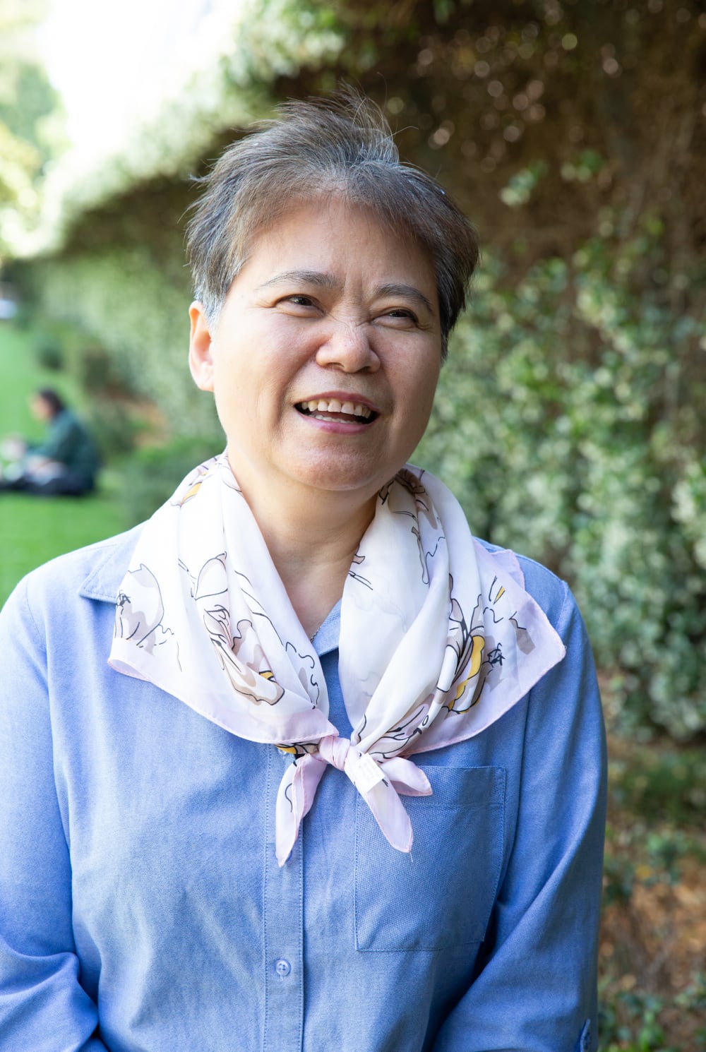 A person standing outside smiling at the camera.