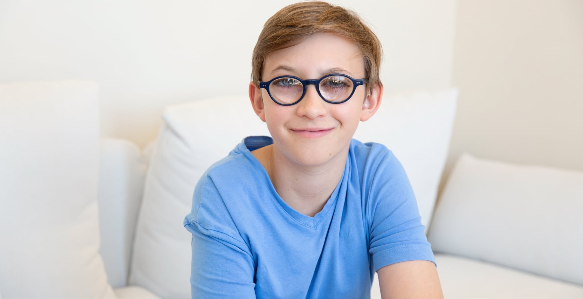 A young child looking at the camera smiling.