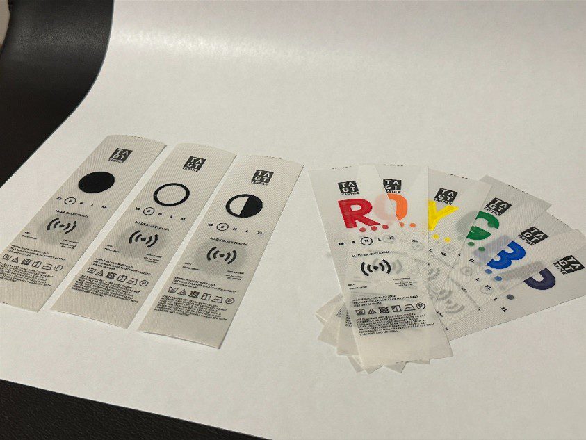 Nine clothing labels with large print letters corresponding to colours.