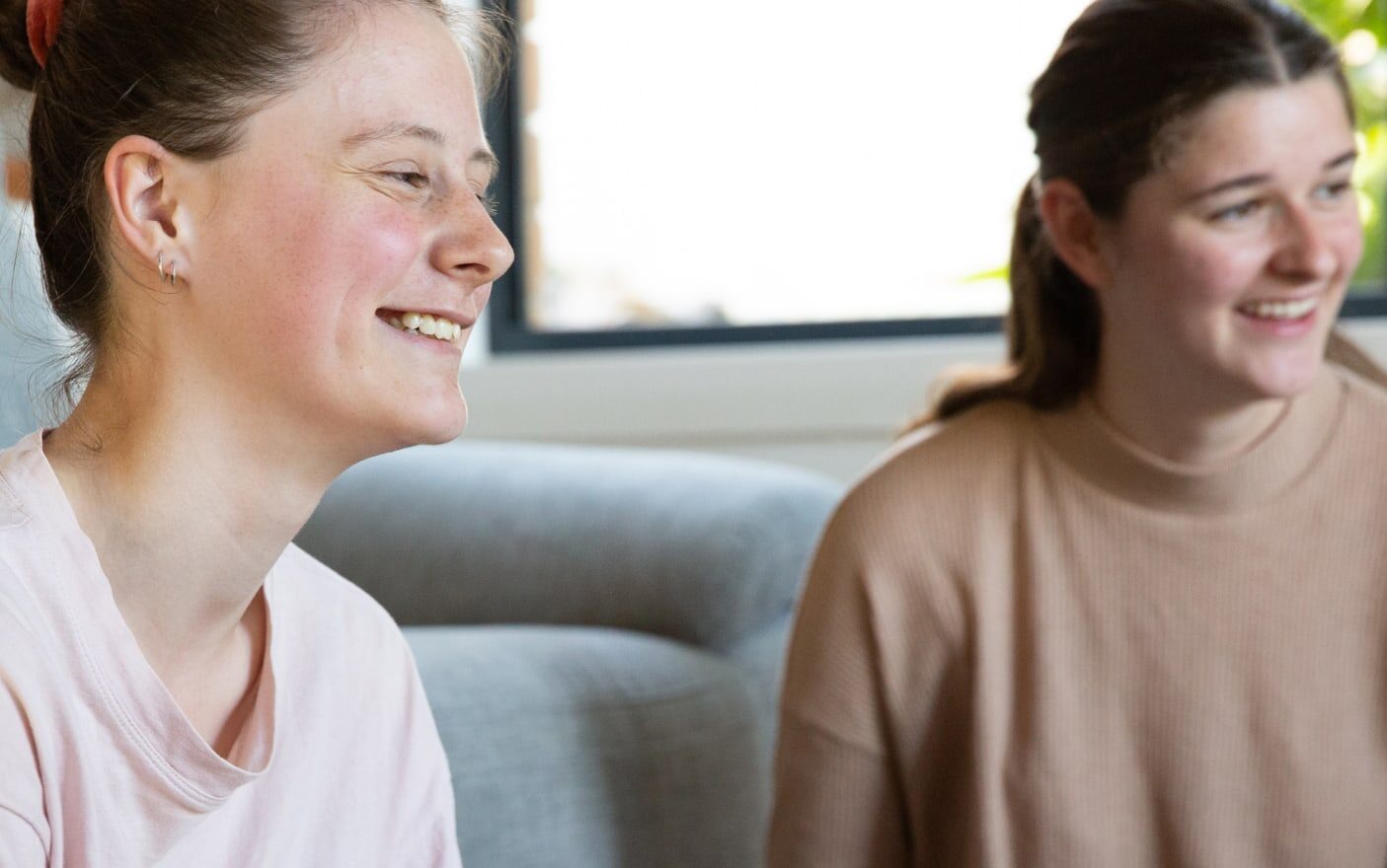 Guide Dogs client smiling while in conversation with her at her lap out of frame
