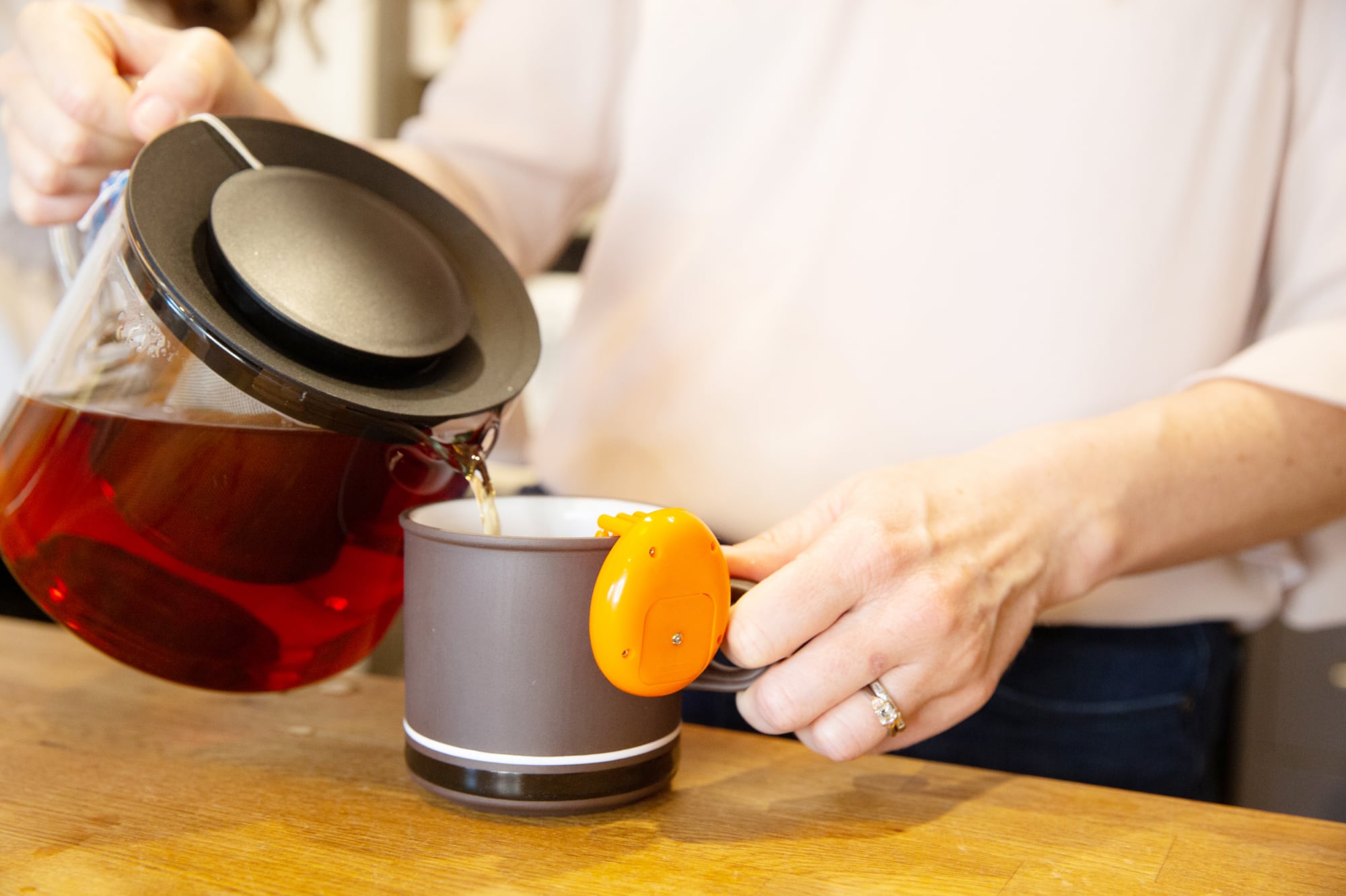 A close up shot of a person making a cup of tea.