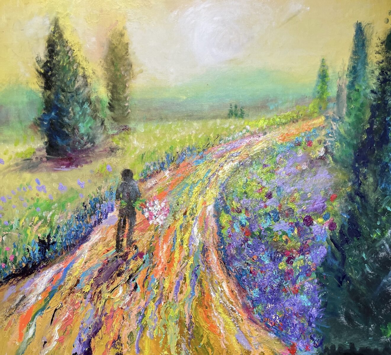 A vibrant painting of a person walking along a colorful, flower-lined path through a bright, sunlit landscape with trees in the distance.