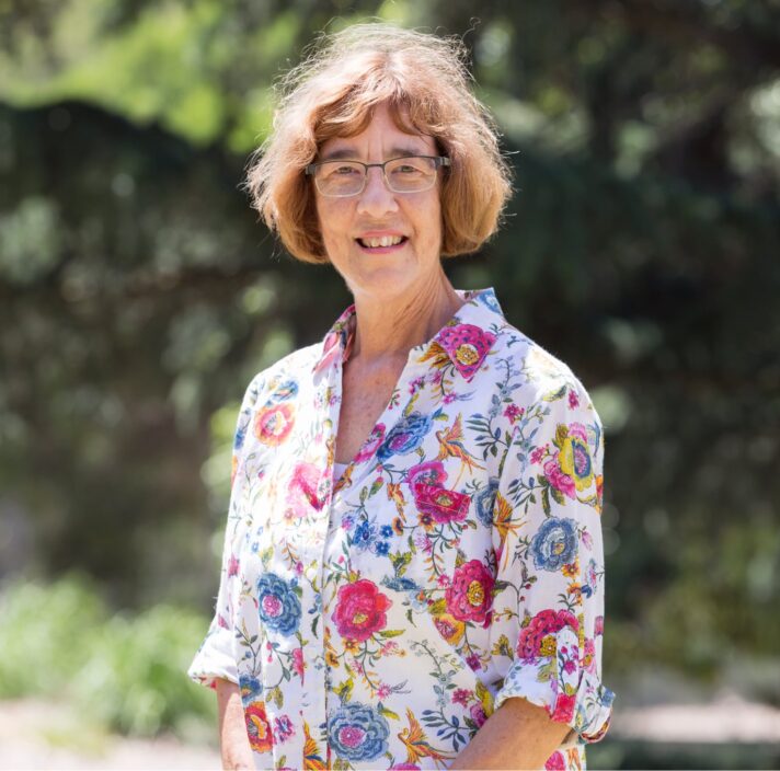 A person standing outside smiling at the camera.