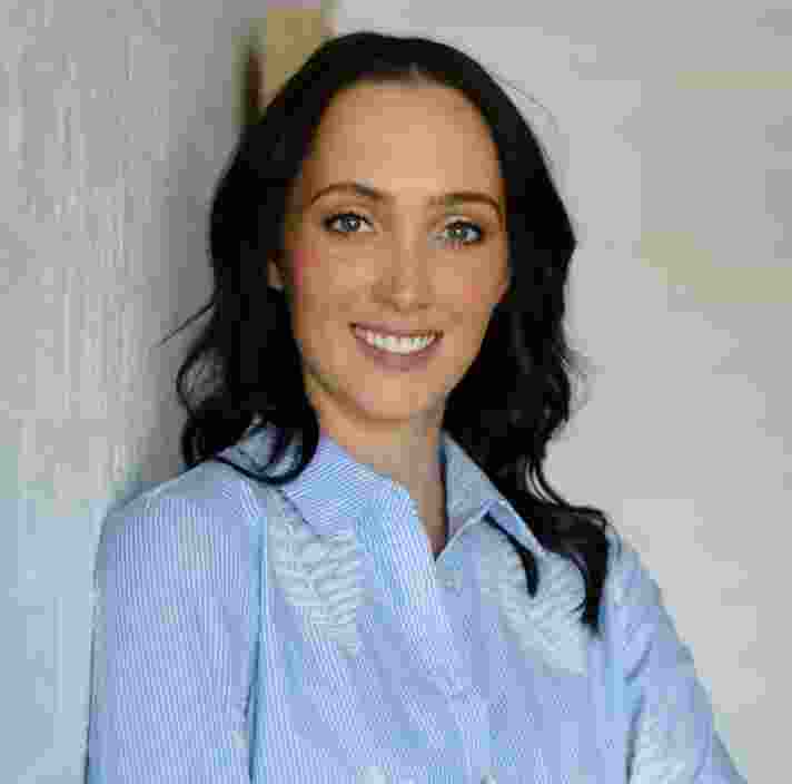 Headshot of Guide Dogs Victoria's Board Director, Jenna Watts. Jenna is looking at the camera smiling.