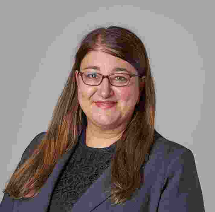 Headshot of Guide Dogs Victorias General Manager of People and Culture, Jo Stavrou. Jo is looking at the camera smiling.