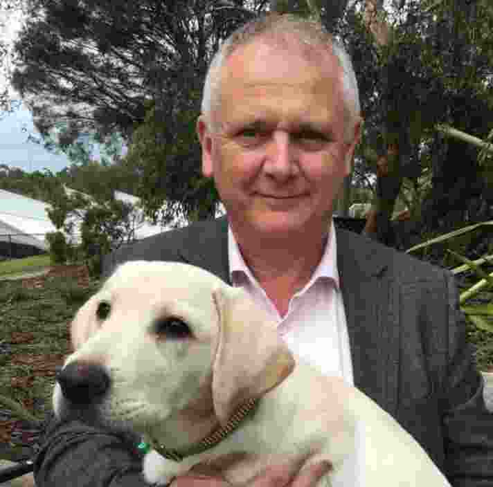 Portrait of Gary Bristow and a yellow Labrador