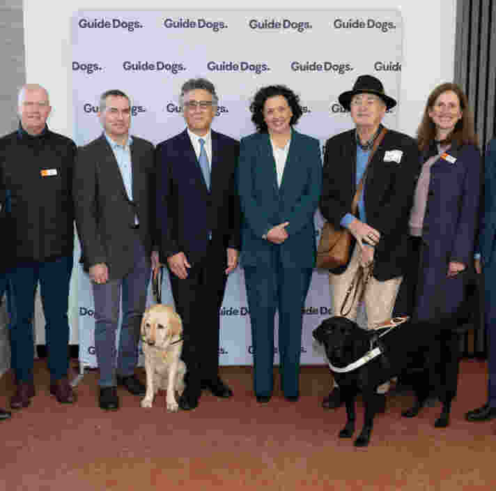 Dr Monique Ryan and Cr Nick Stavrou (centre) stands with various members of the Guide Dogs Victoria Board and GDV Client Cameron.