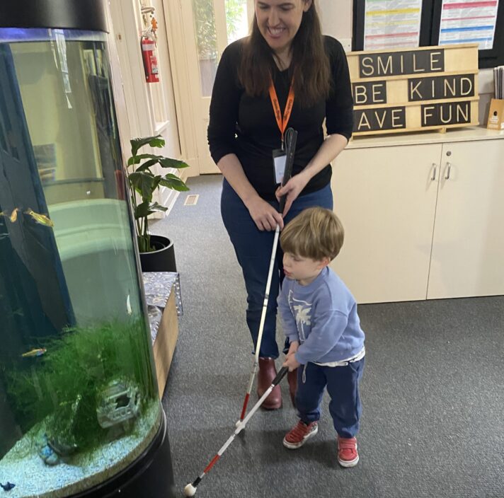 Erin and Louie navigating the kindergarten with their white canes.