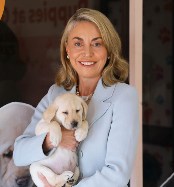 Nicky Long holding a yellow Labrador puppy